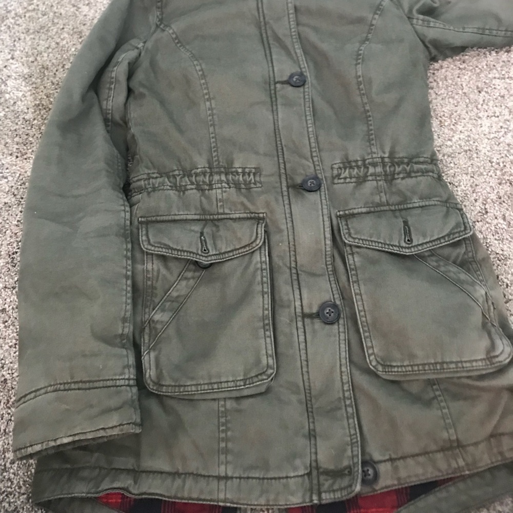 a green jacket with a hood very worm and comfy